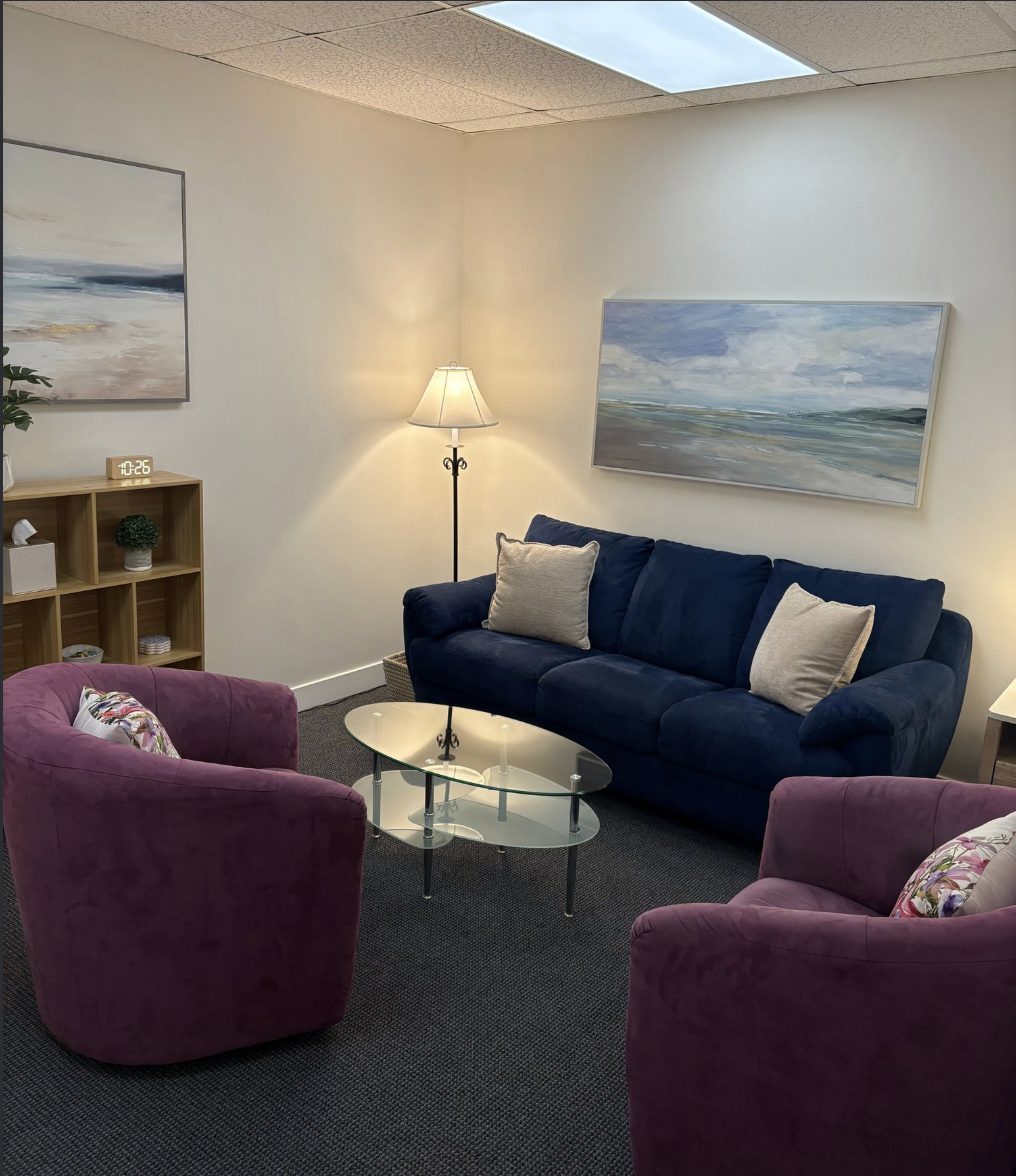 Therapy office in Westlake Village, California, with a sofa, two armchairs and warm lamp light